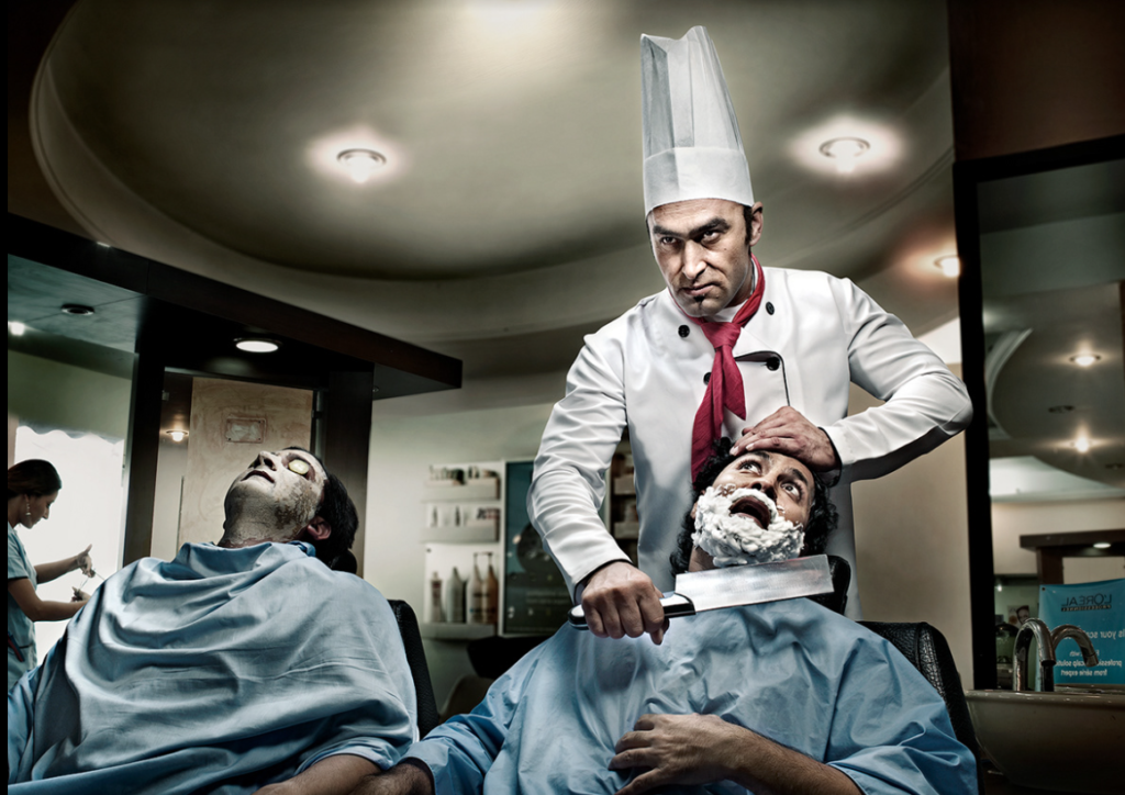 A green, hairy monster with a worried expression stands behind a salon chair, holding a giant chef's knife instead of barber shears. A human customer sits nervously in the chair.